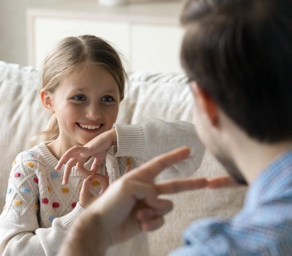 Adult and child using sign language